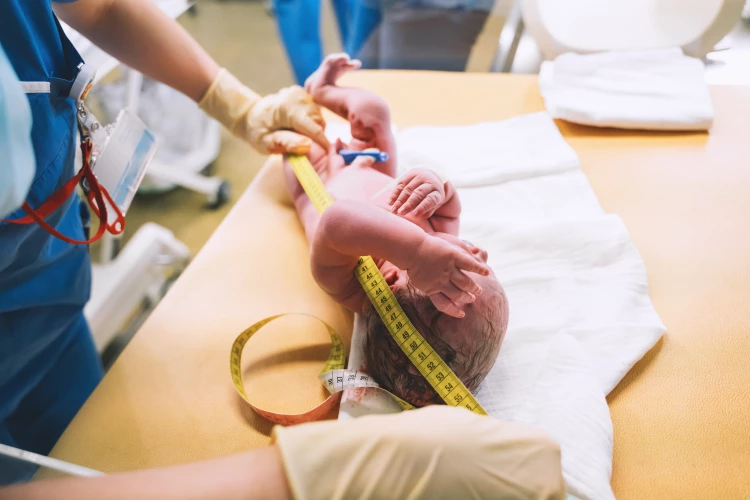 midwife measuring baby