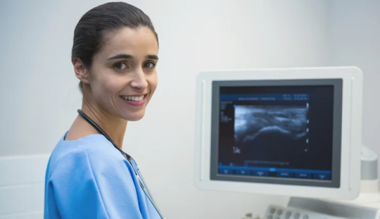 cardiac sonographer next to monitor