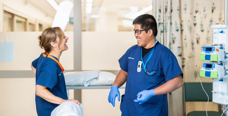 Two critical care nurses preparing the room for the next patient whilst having a pleasant discussion