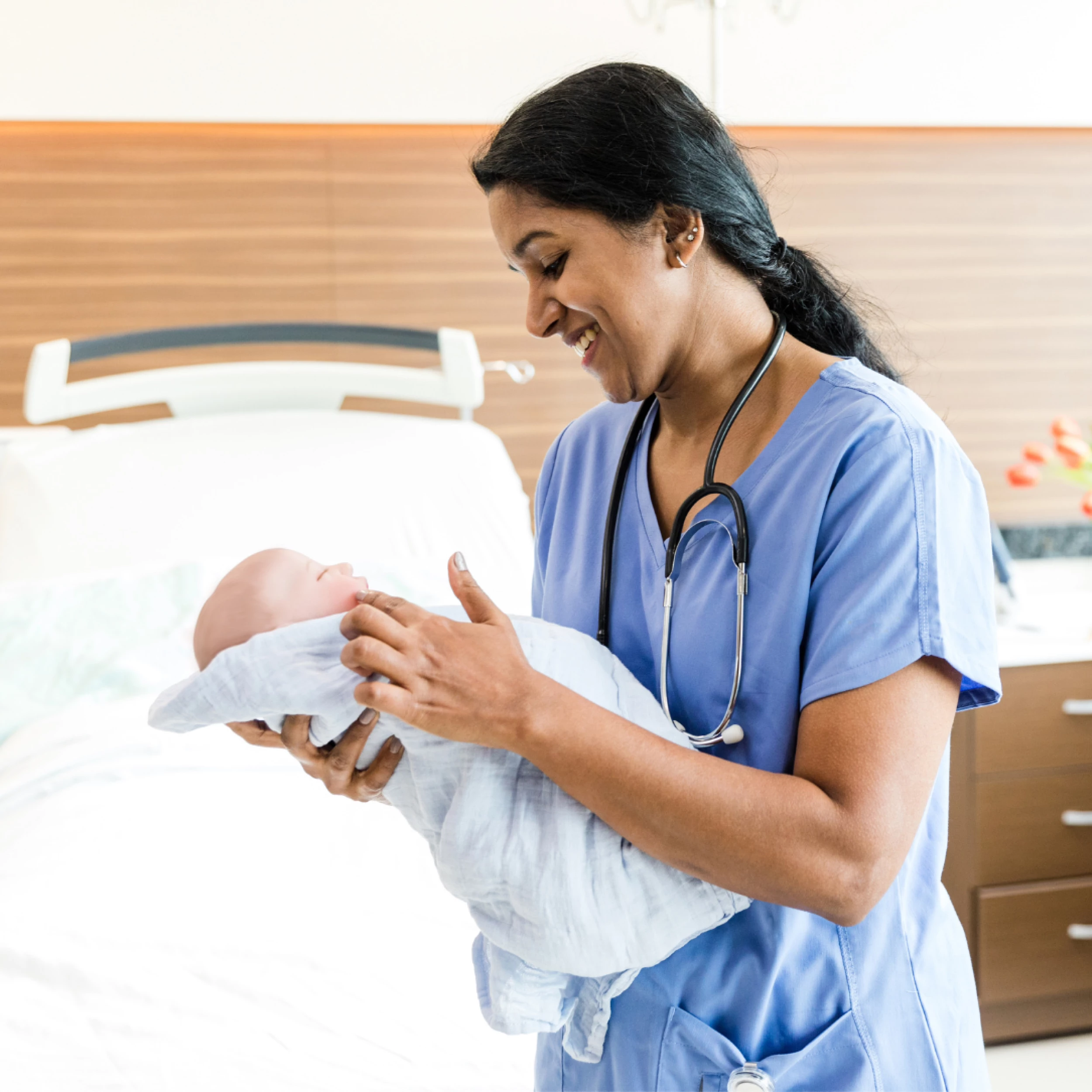 Midwife with newborn baby (stock image)