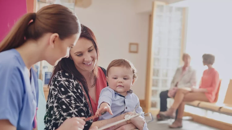 Paediatrician with baby (stock image)