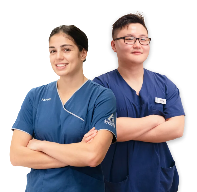 Registered nurses Alicia and Pyong standing side-by-side with arms crossed