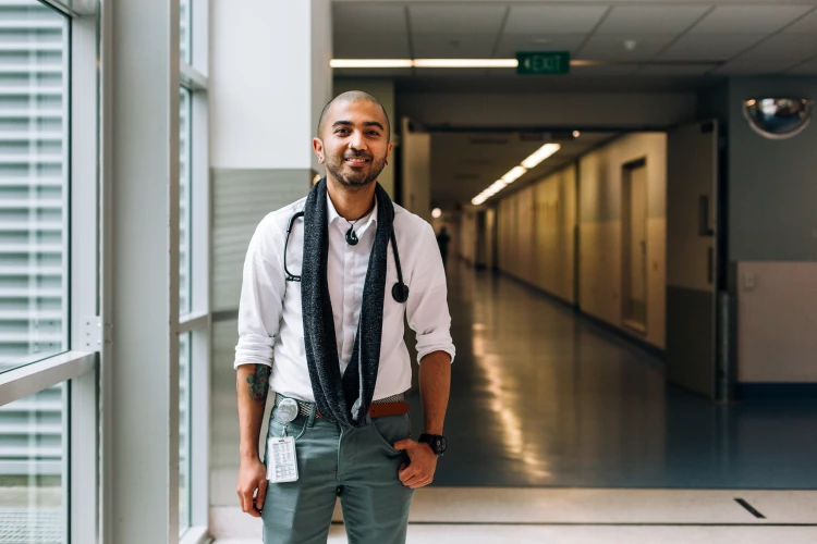 Senior Medical Officer Zaffer standing in the hospital corridor by the large windows.